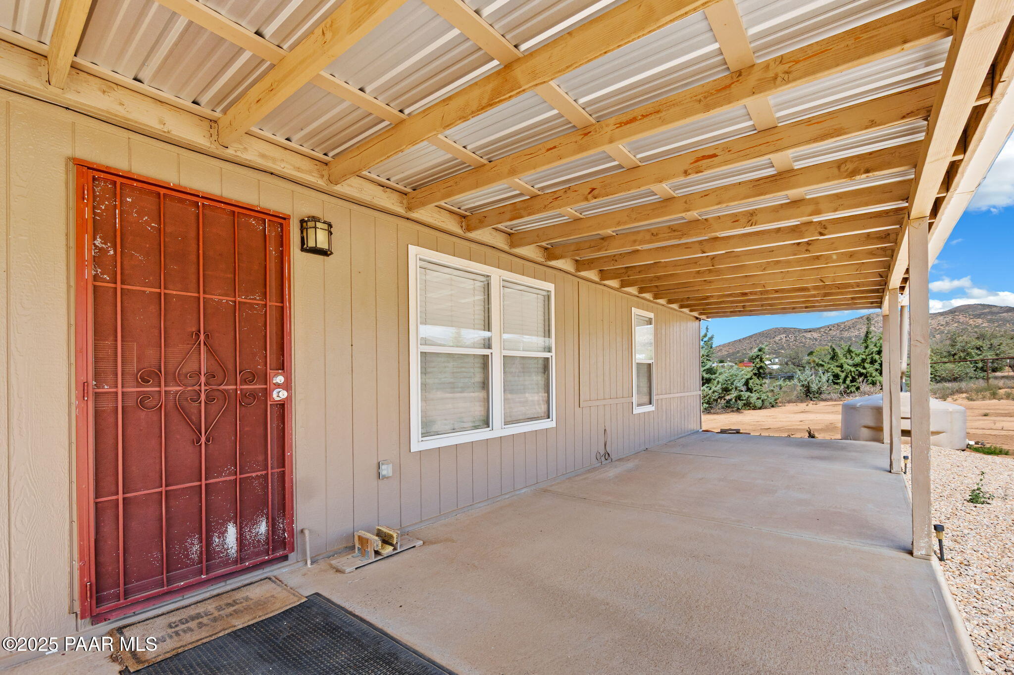 18125 East Roper Way Dewey, AZ 86327 - Photo 3 of 63 a view of a room with wooden walls and iron stairs