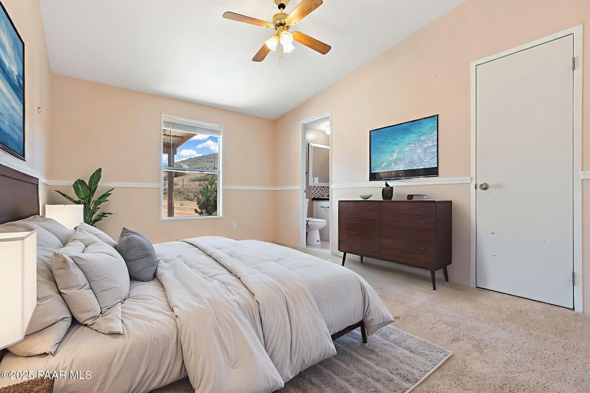 18125 East Roper Way Dewey, AZ 86327 - Photo 31 of 63 a bedroom with a bed and a painting on the wall