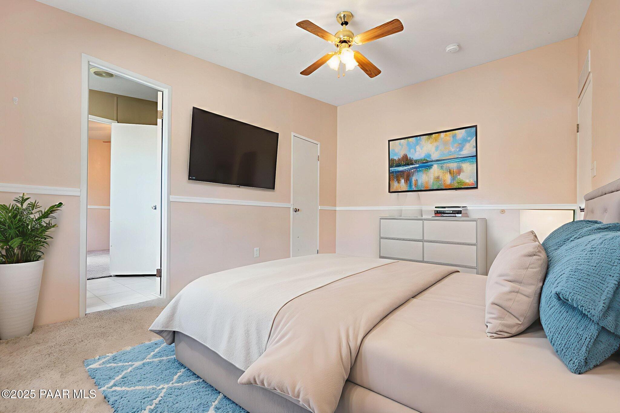 18125 East Roper Way Dewey, AZ 86327 - Photo 33 of 63 a bedroom with a large bed and a flat screen tv