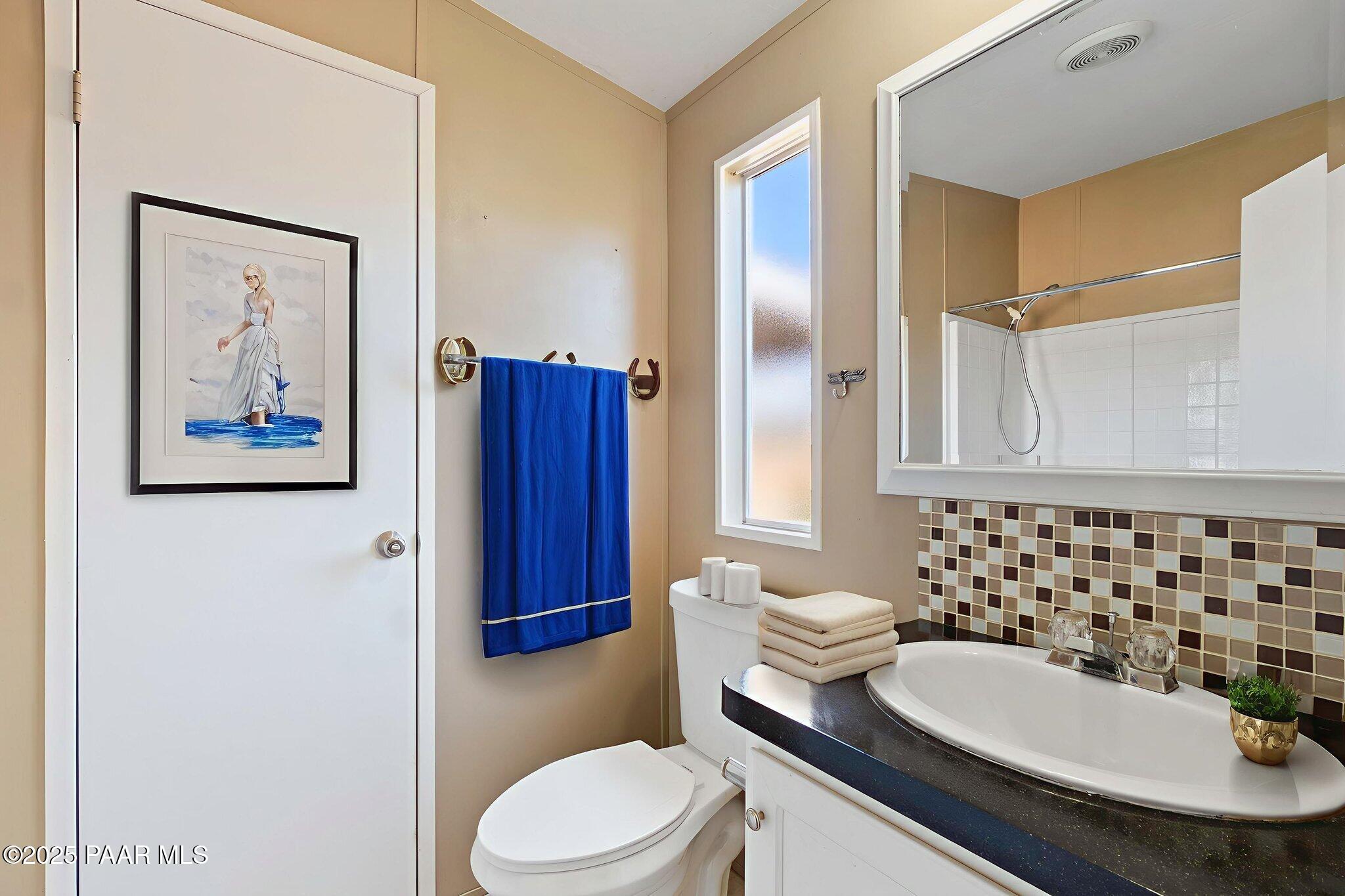 18125 East Roper Way Dewey, AZ 86327 - Photo 35 of 63 a bathroom with a sink a toilet and shower curtain