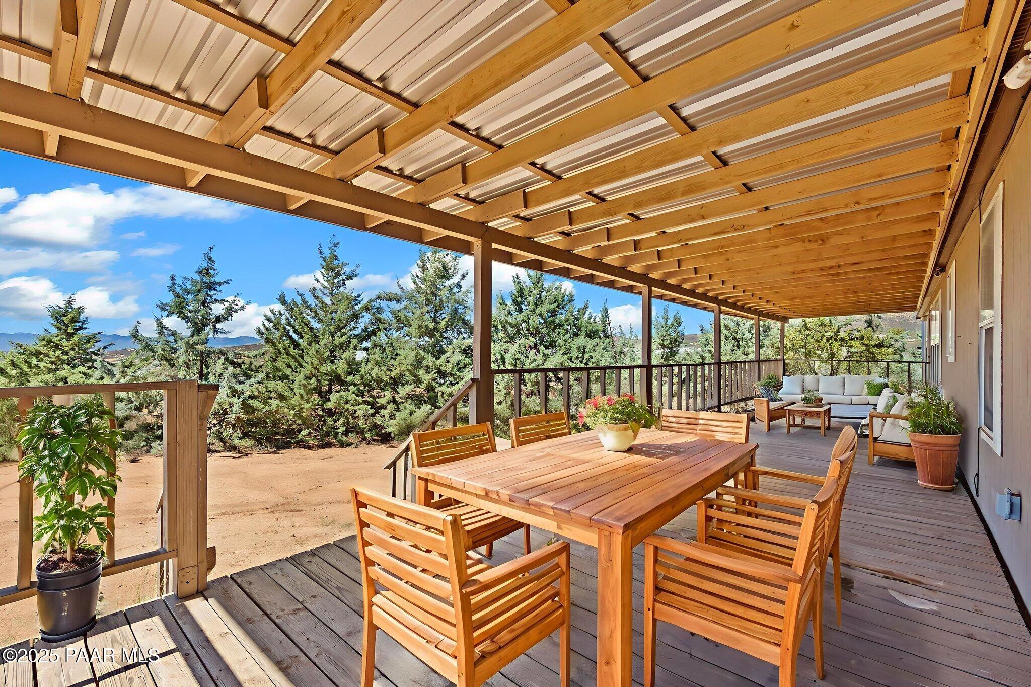 18125 East Roper Way Dewey, AZ 86327 - Photo 44 of 63 a view of a patio with table and chairs and wooden floor