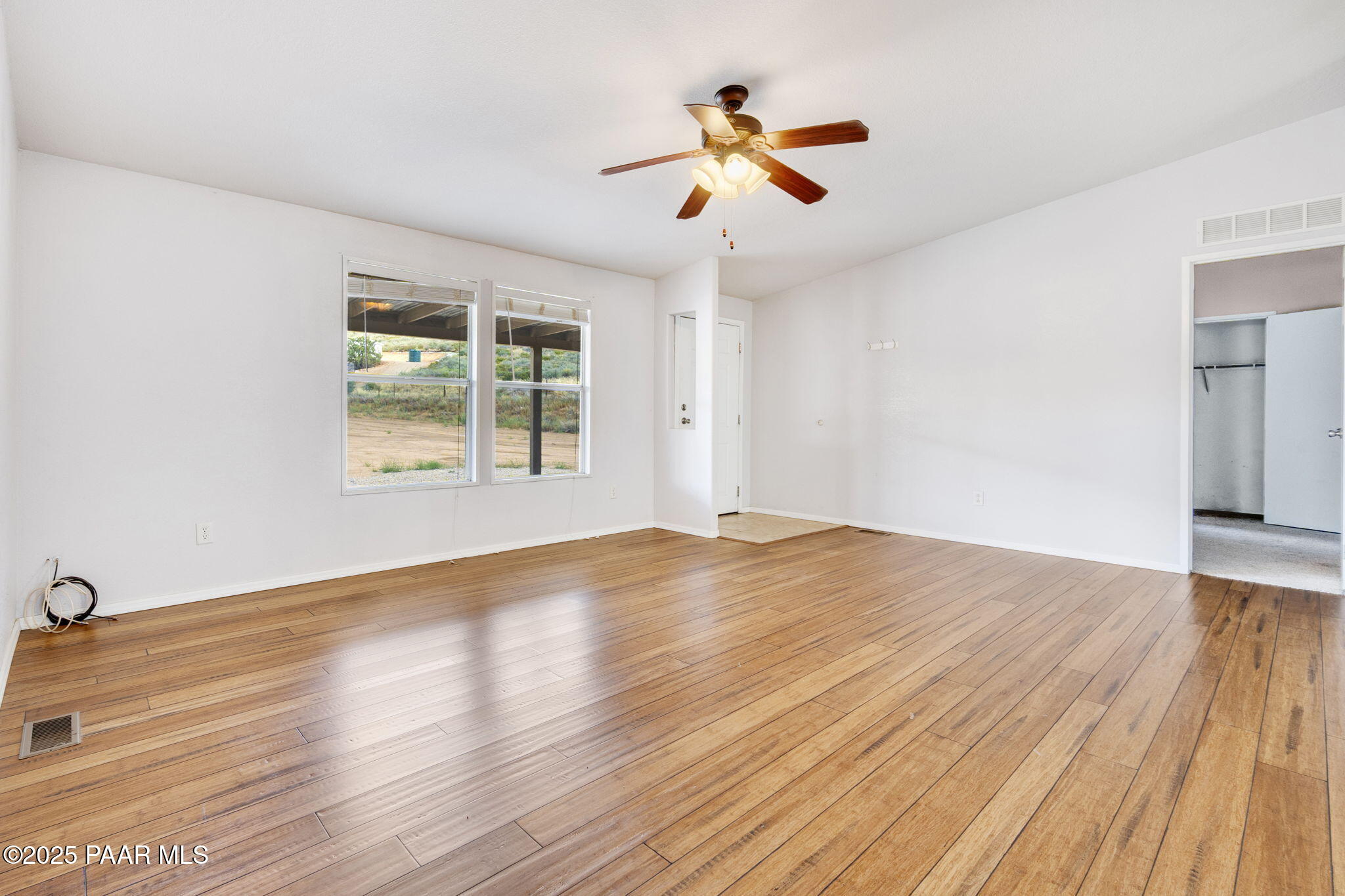 18125 East Roper Way Dewey, AZ 86327 - Photo 7 of 63 a view of empty room with wooden floor and fan