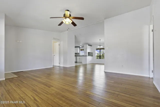 a living room with furniture and kitchen view