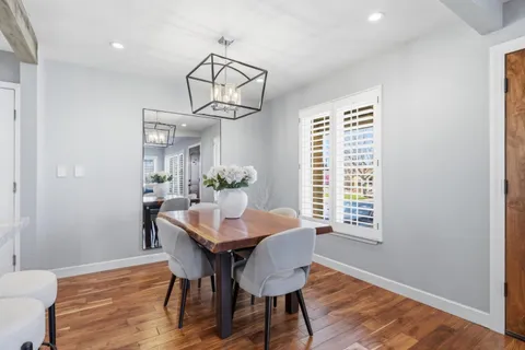 a view of a dining room with furniture window and wooden floor