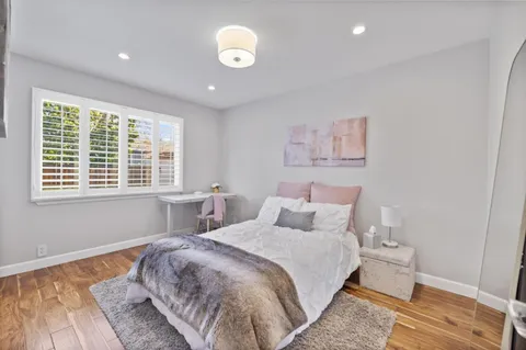 a bedroom with a large bed and a window