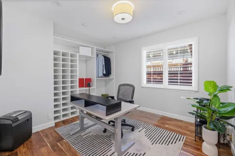 a workspace with furniture and a potted plant