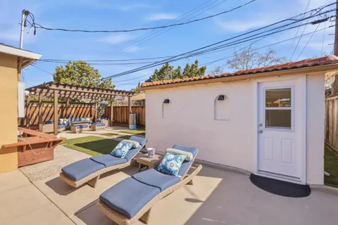 a view of a patio with a table and chairs