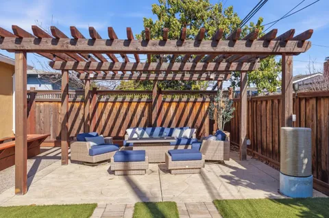 a view of a chairs and tables in the back yard of the house