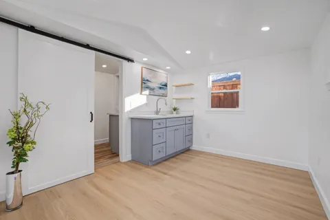 a kitchen with a wooden floor and cabinets