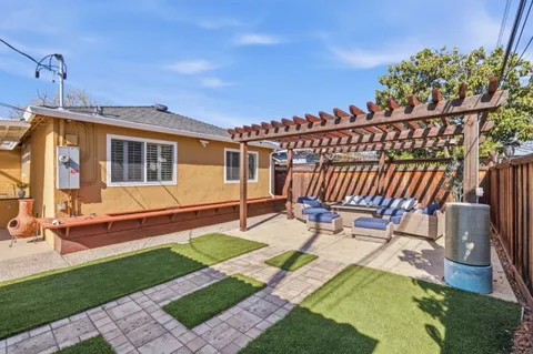 a view of a house with backyard porch and sitting area
