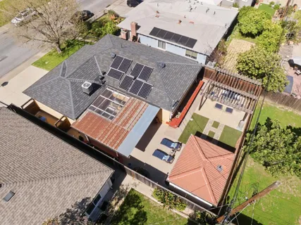 an aerial view of a house with a yard