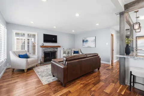 a living room with furniture a flat screen tv and a fireplace