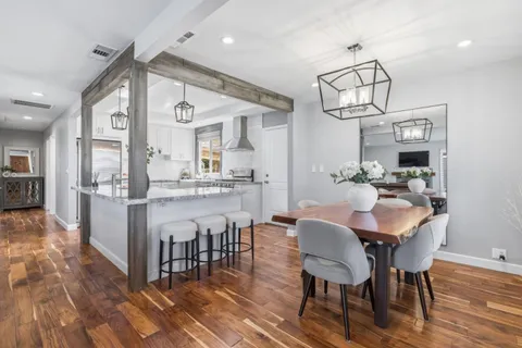 a view of a dining room with furniture wooden floor and chandelier