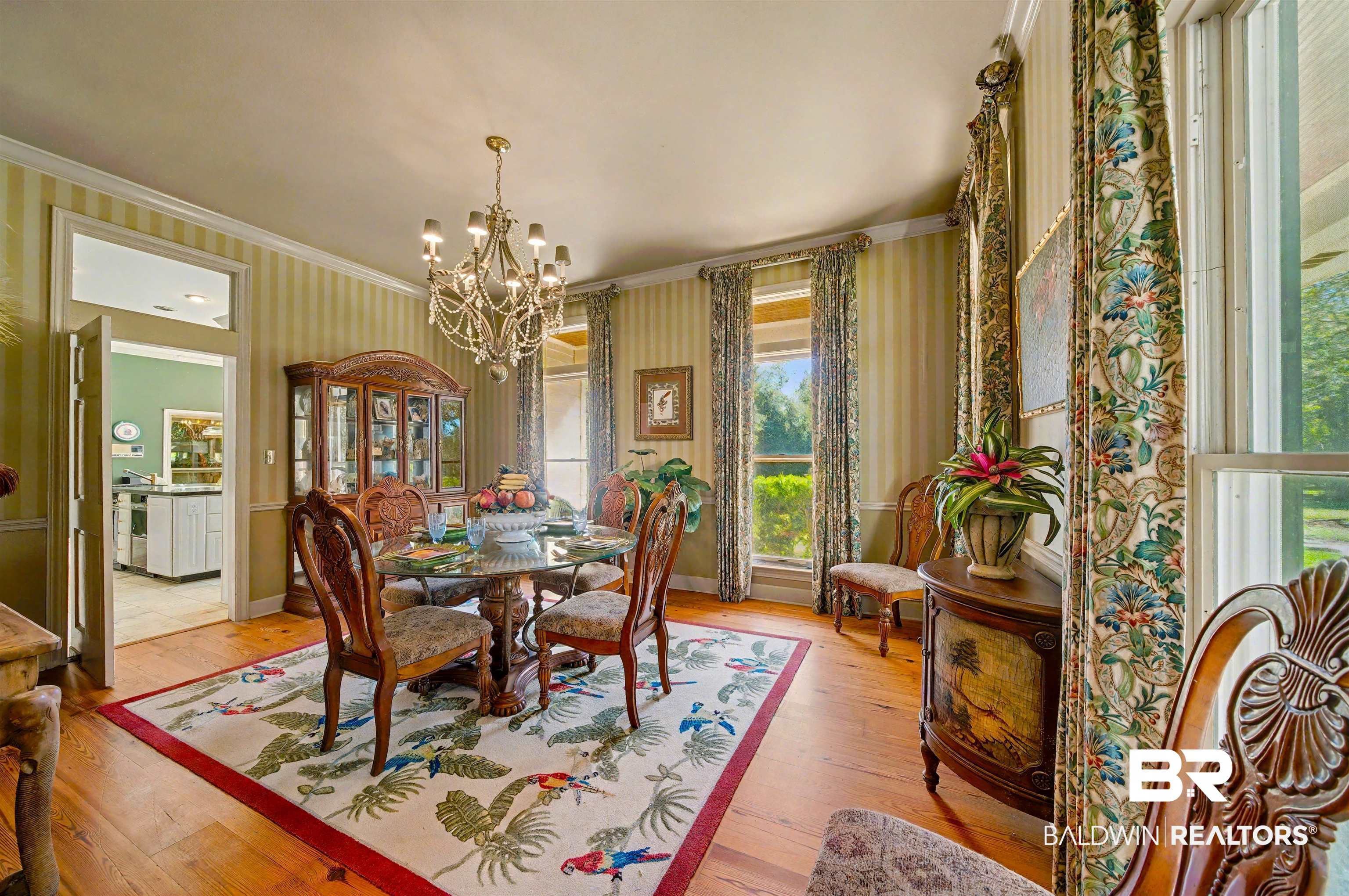 15810 County Road 73 Foley, AL 36535 - Photo 23 of 56 Dining space with wallpapered walls, ornamental molding, wood-type flooring, and a chandelier