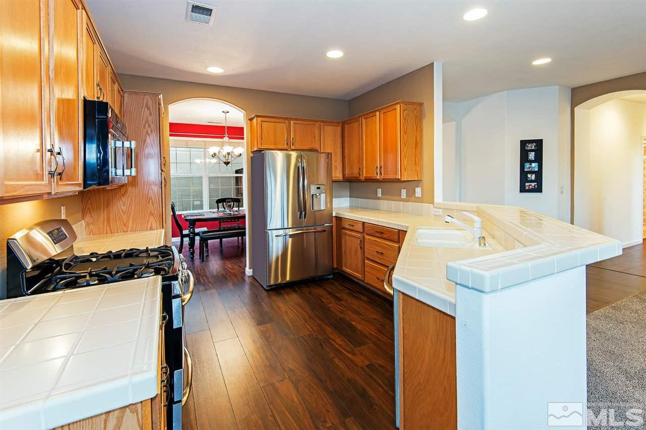 10411 Summershade Lane Reno, NV 89521 - Photo 1 of 1 a kitchen with stainless steel appliances granite countertop a sink and a refrigerator