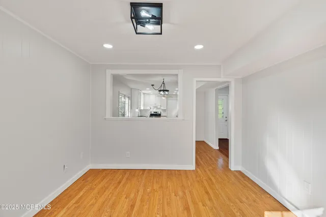a view of a big room with wooden floor and a bathroom