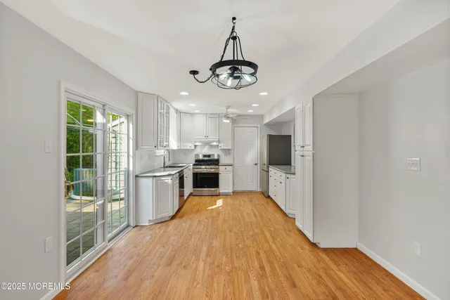 a view of a kitchen with stove and cabinets