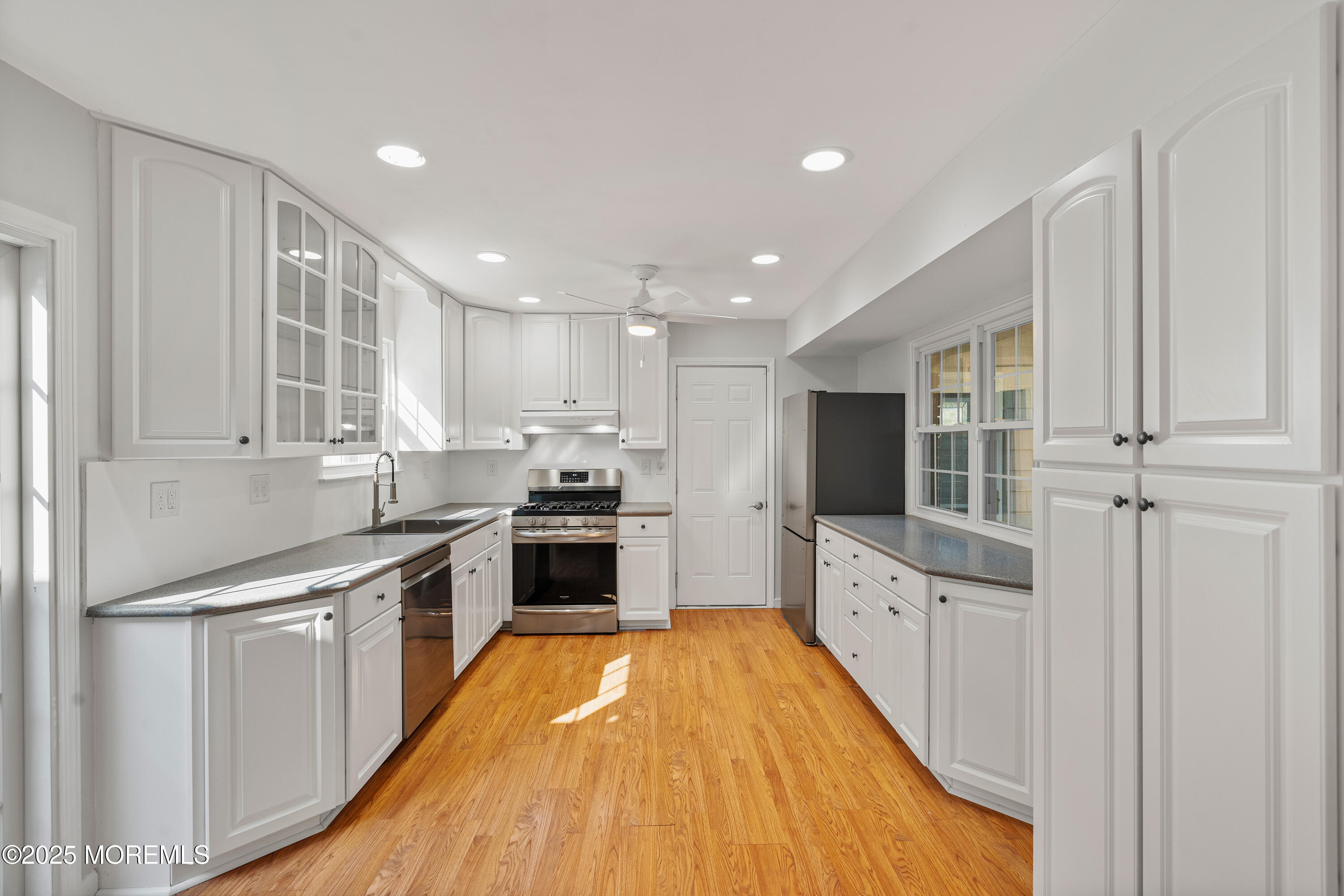 61 Berkshire Drive Howell, NJ 07731 - Photo 16 of 43 a large kitchen with stainless steel appliances granite countertop a stove a sink and a refrigerator