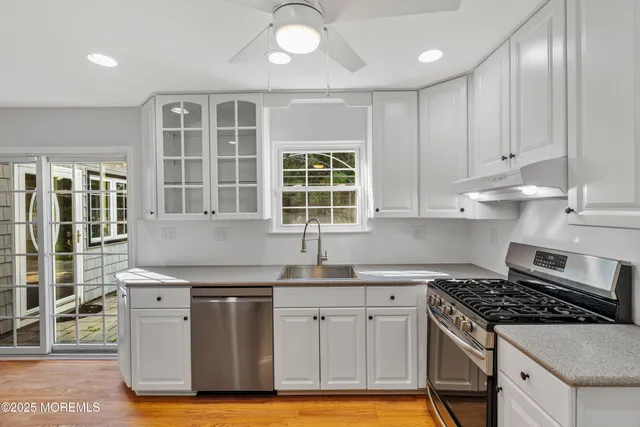 a kitchen with granite countertop a stove and a sink