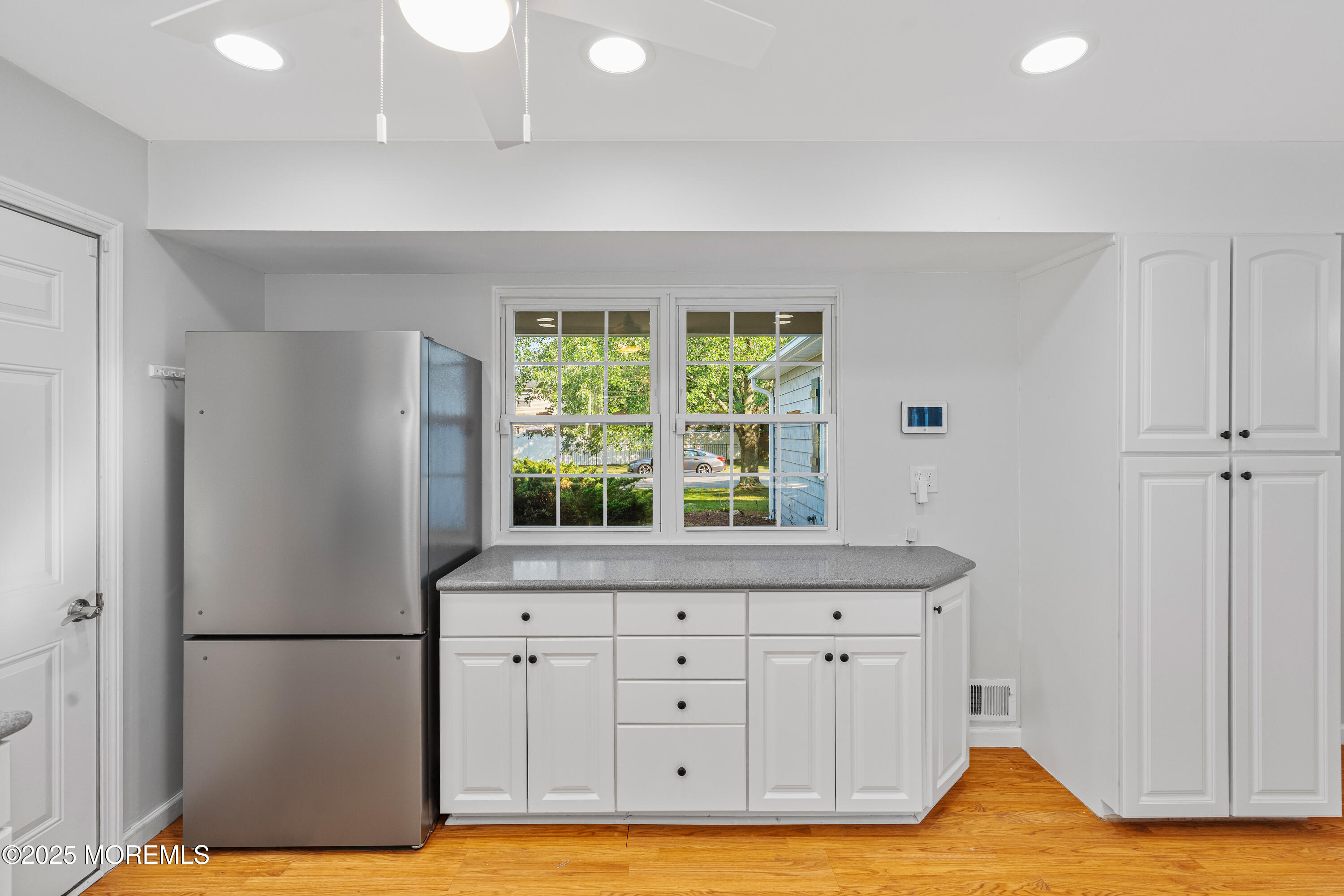 61 Berkshire Drive Howell, NJ 07731 - Photo 19 of 43 a view of a kitchen with furniture and a window