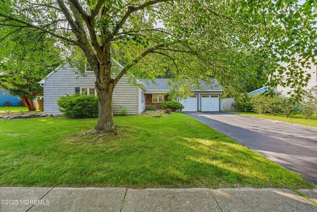 a front view of house with yard and green space