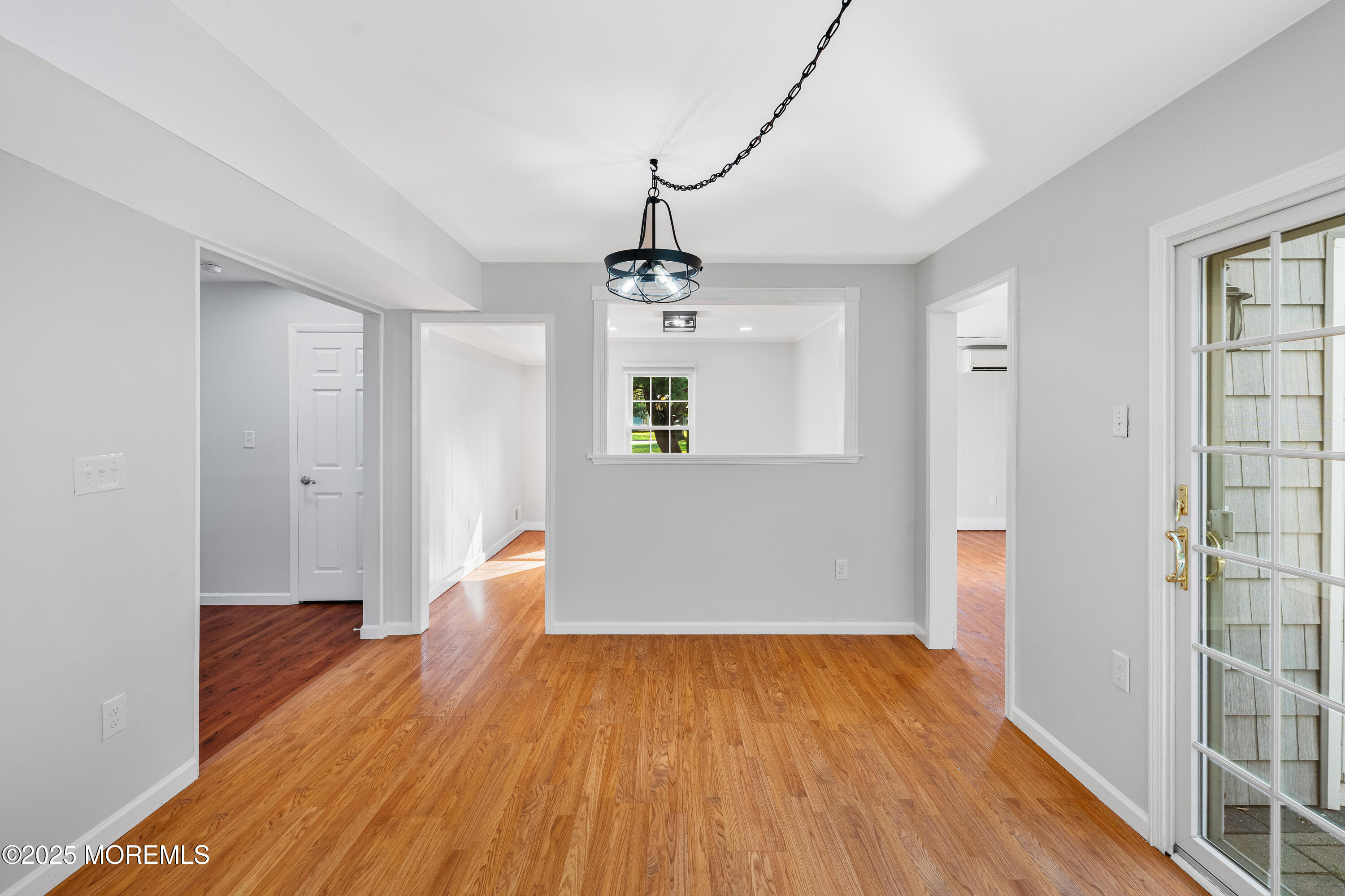 61 Berkshire Drive Howell, NJ 07731 - Photo 22 of 43 a view of an empty room with wooden floor and a window