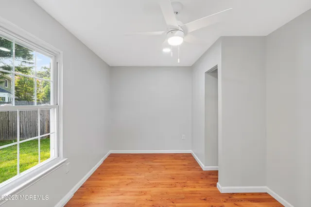 a view of a room with wooden floor and natural light