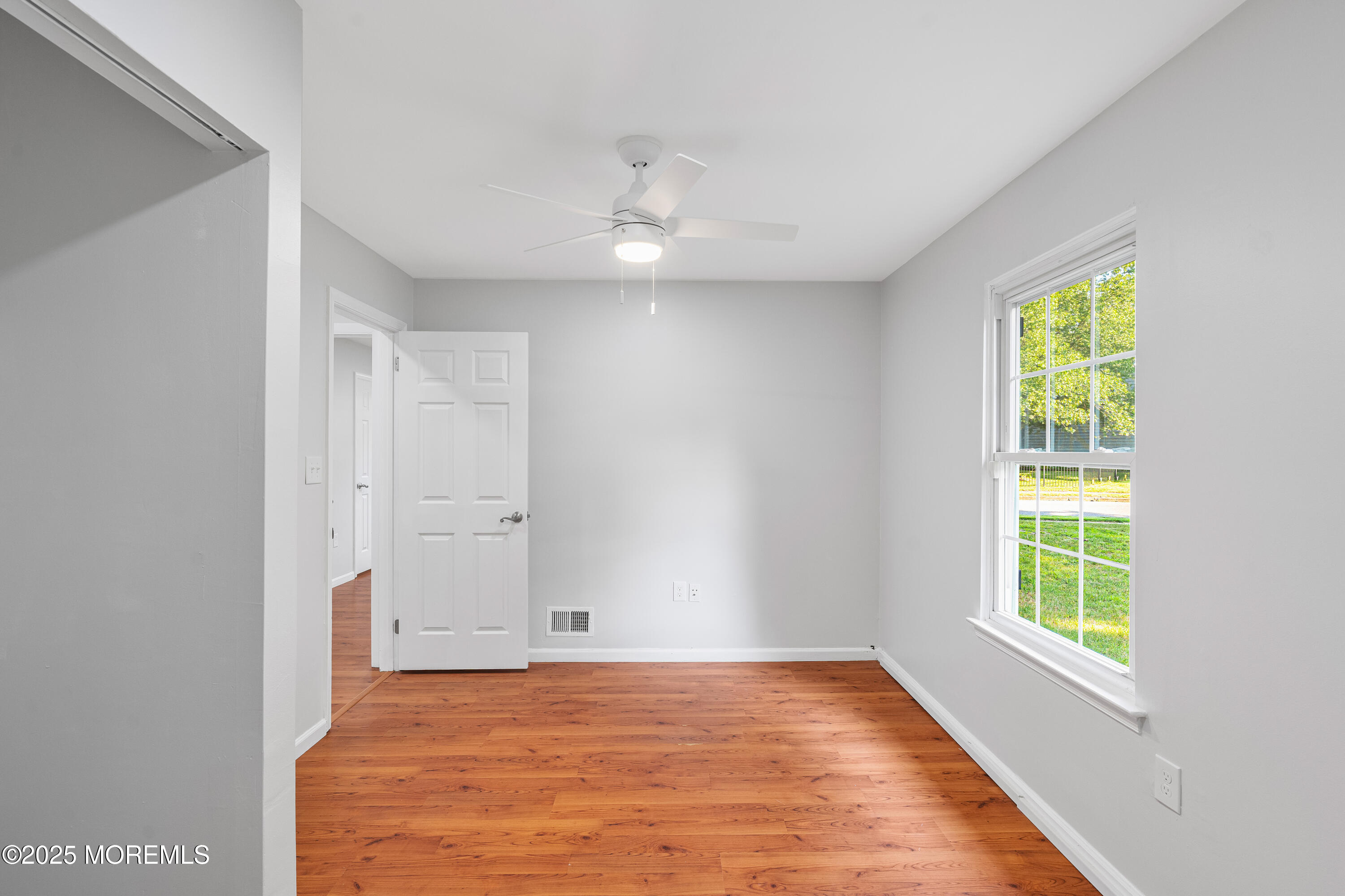61 Berkshire Drive Howell, NJ 07731 - Photo 27 of 43 wooden floor in an empty room with a window