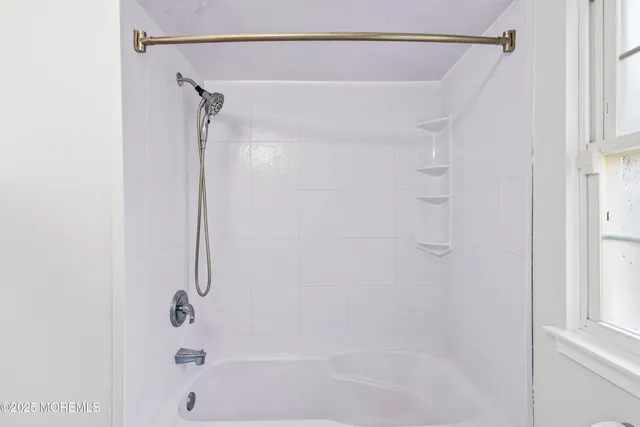 a bathroom with a shower and a bath tub