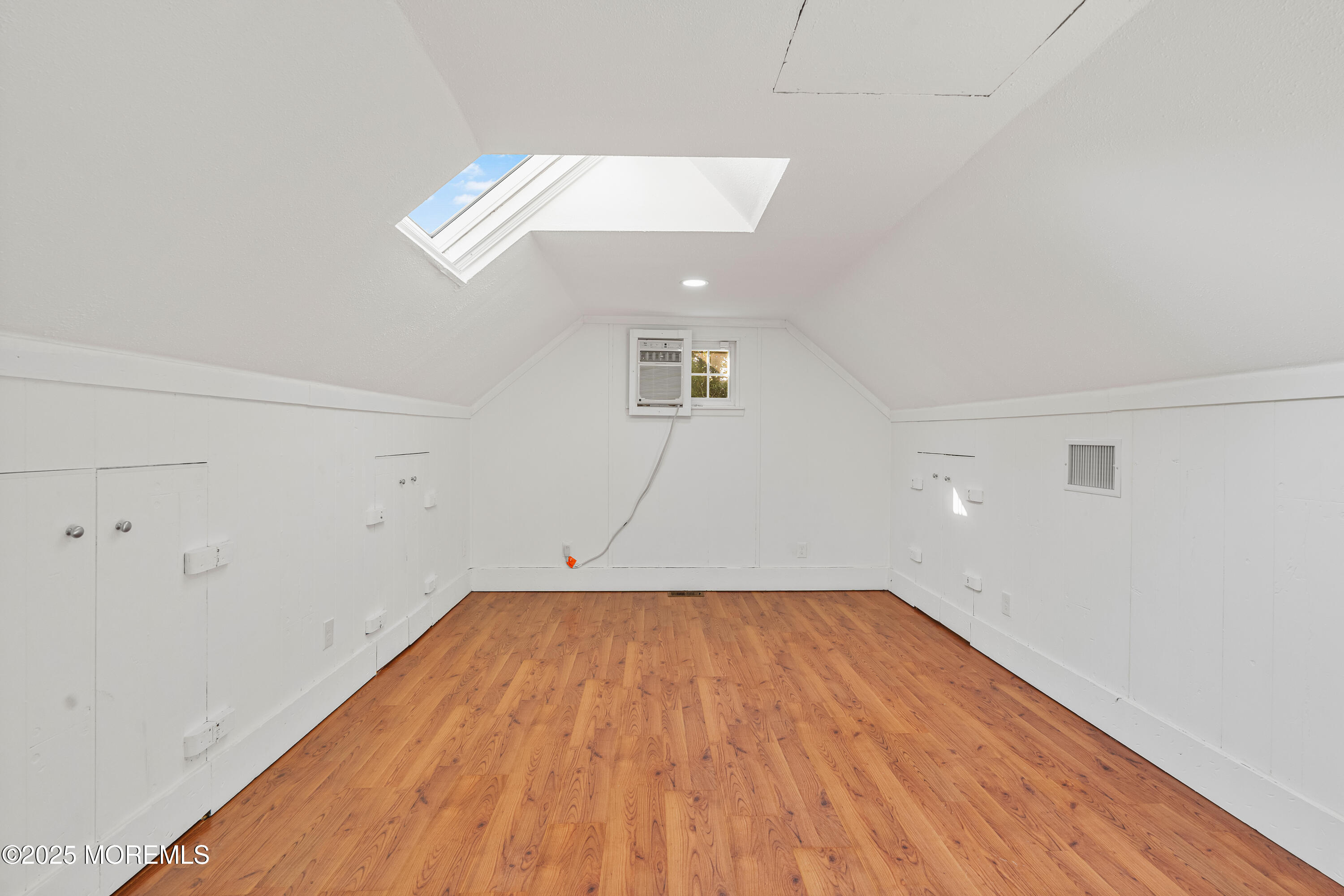 61 Berkshire Drive Howell, NJ 07731 - Photo 37 of 43 an empty room with wooden floor and windows