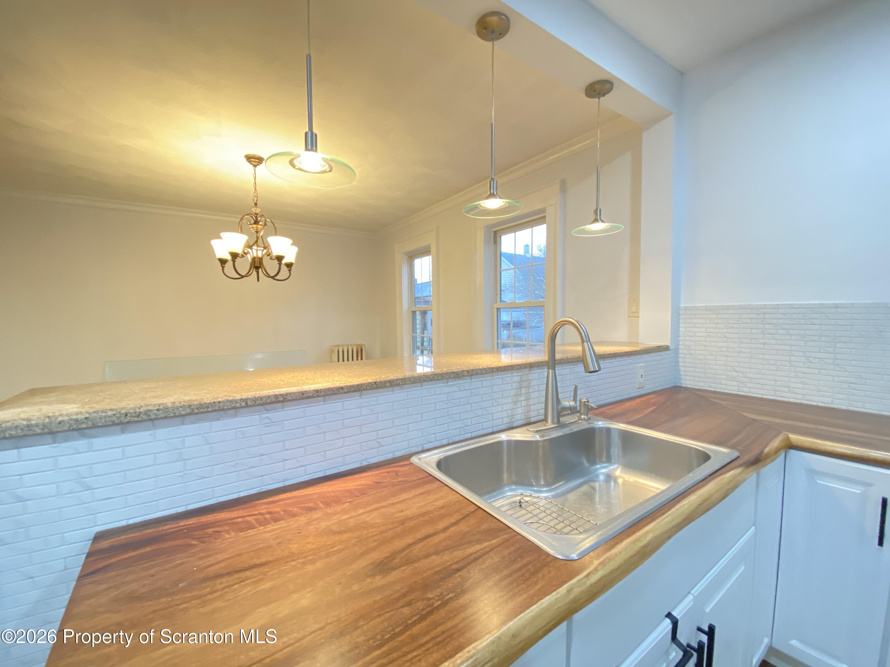 1827 Prospect Avenue Scranton, PA 18505 - Photo 13 of 48 a view of a kitchen with a sink and chandelier