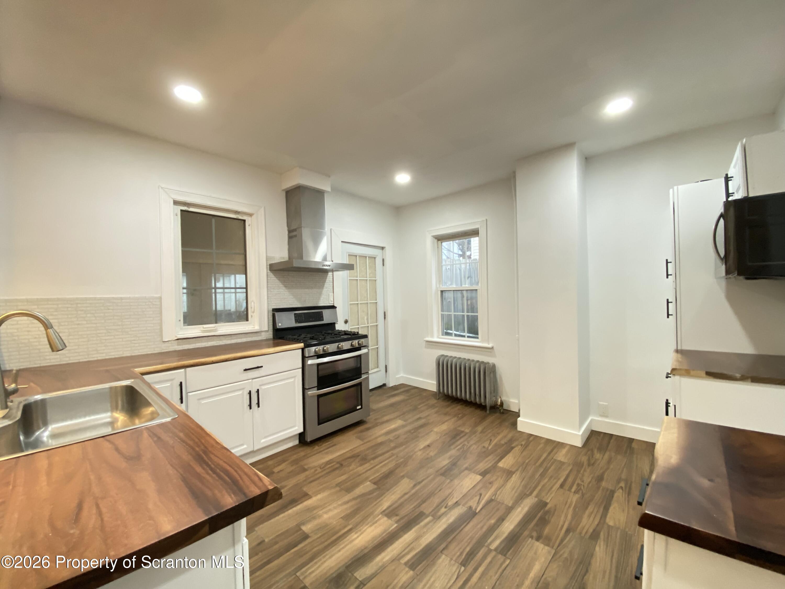 1827 Prospect Avenue Scranton, PA 18505 - Photo 14 of 48 a kitchen with granite countertop a stove and a sink