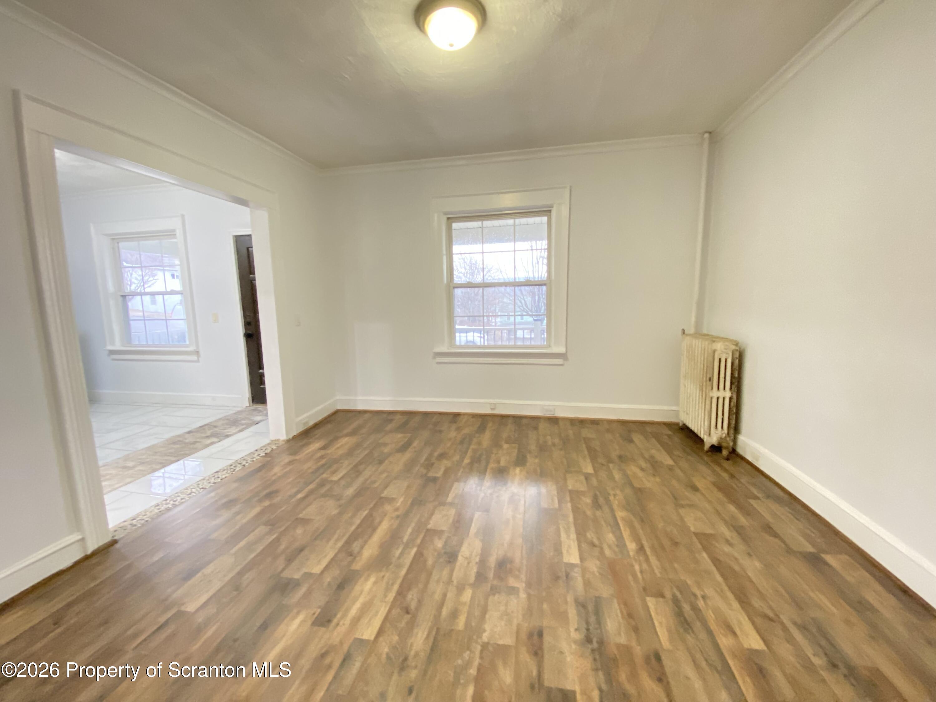 1827 Prospect Avenue Scranton, PA 18505 - Photo 20 of 48 an empty room with wooden floor and windows