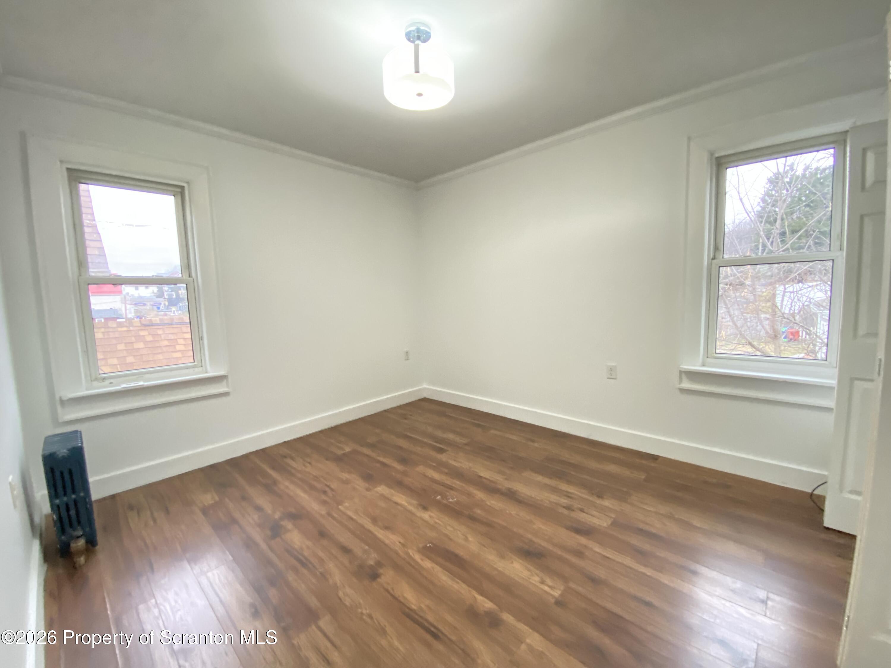 1827 Prospect Avenue Scranton, PA 18505 - Photo 28 of 48 a view of an empty room with wooden floor and a window