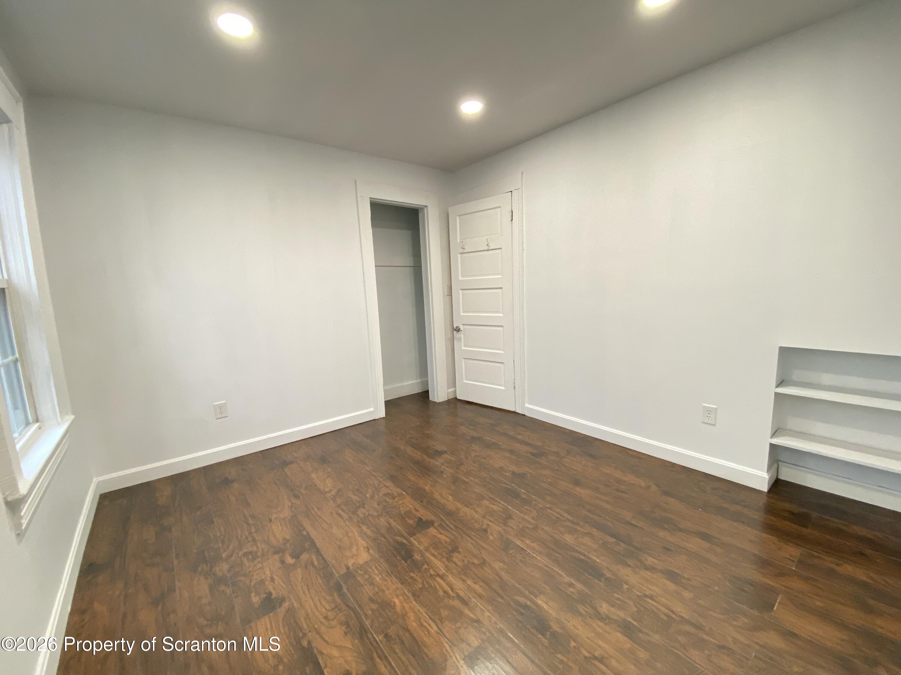 1827 Prospect Avenue Scranton, PA 18505 - Photo 33 of 48 an empty room with wooden floor and windows
