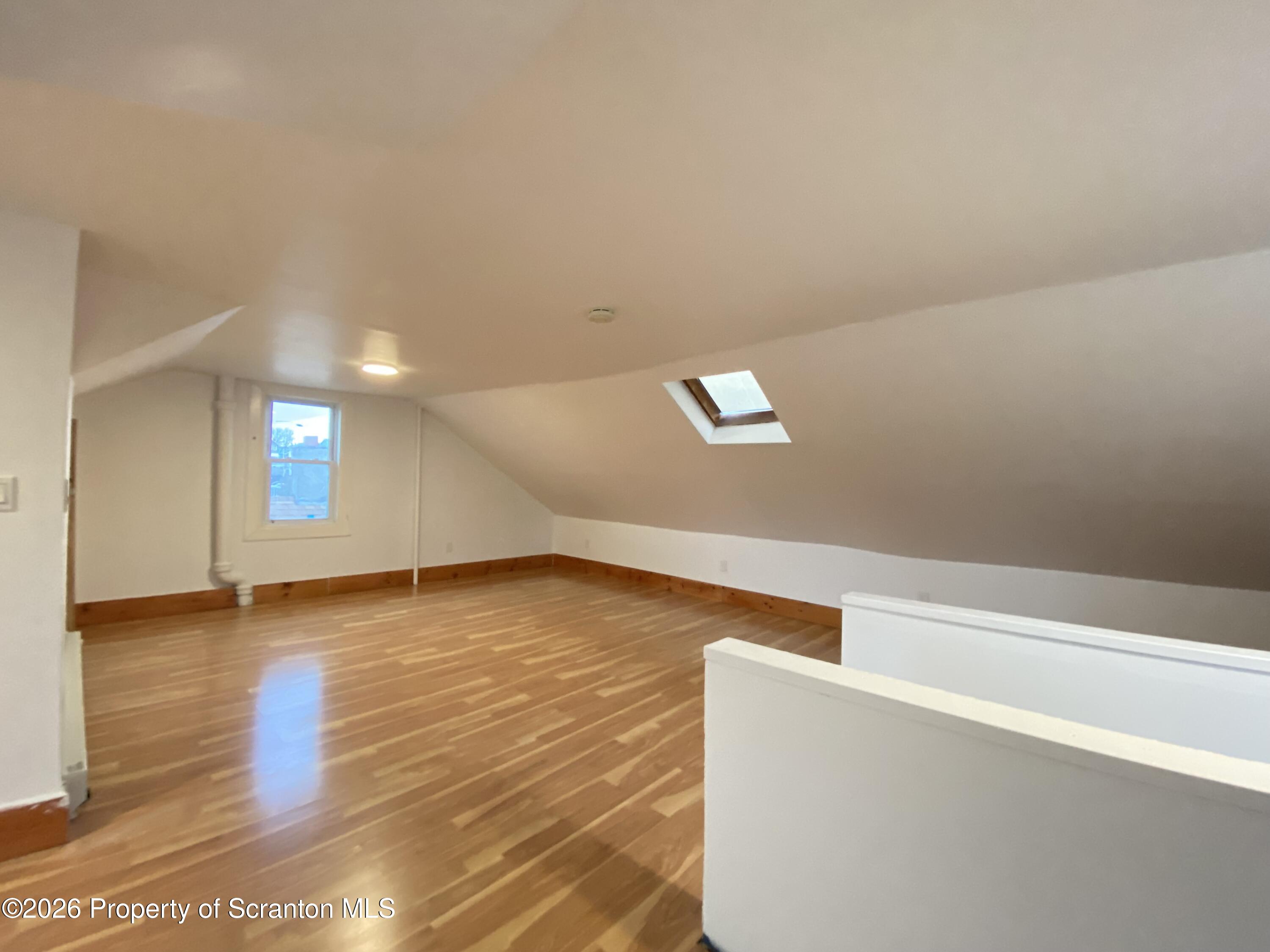 1827 Prospect Avenue Scranton, PA 18505 - Photo 35 of 48 a view of an empty room with wooden floor