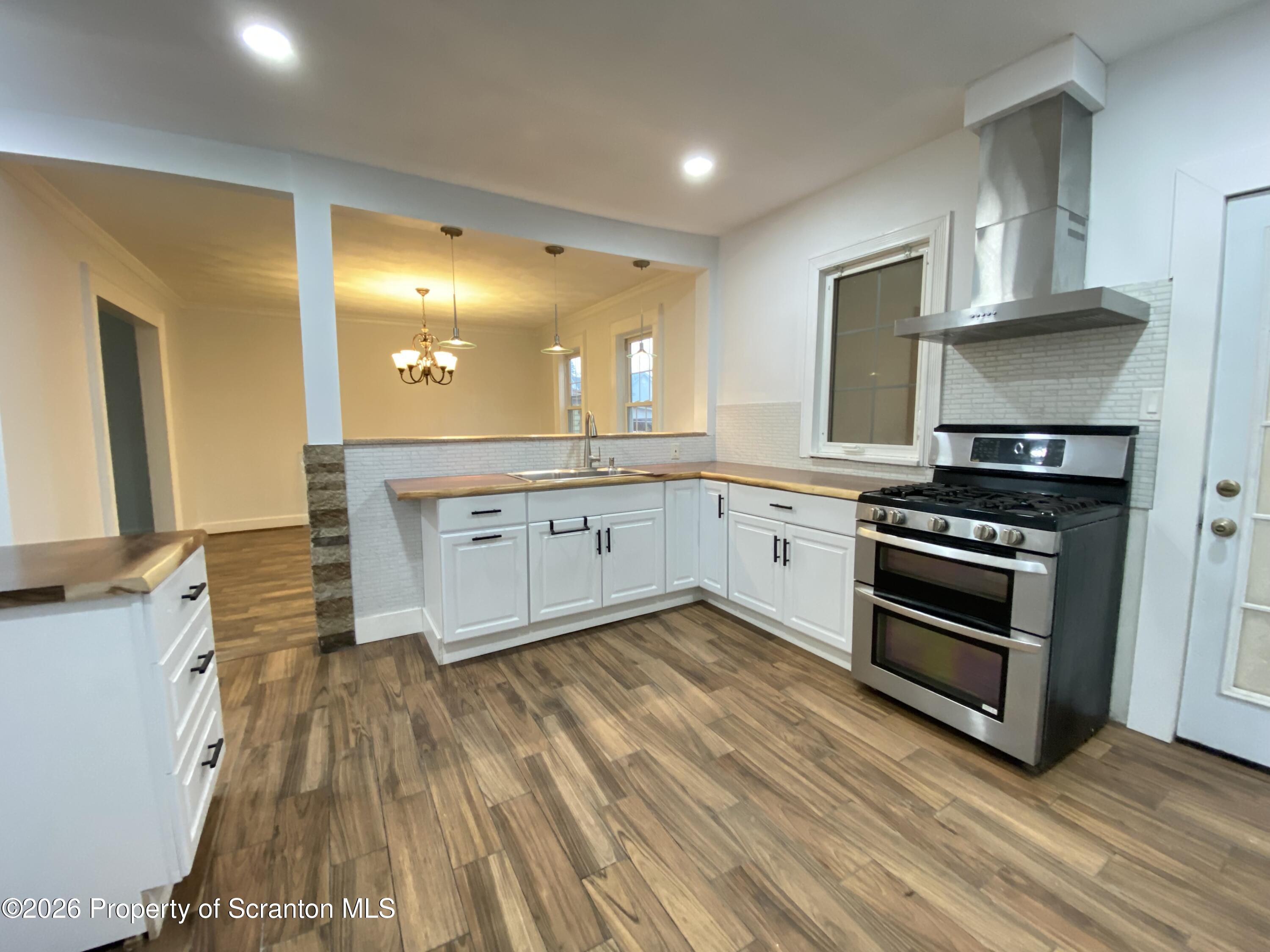 1827 Prospect Avenue Scranton, PA 18505 - Photo 10 of 48 a large kitchen with cabinets and stainless steel appliances
