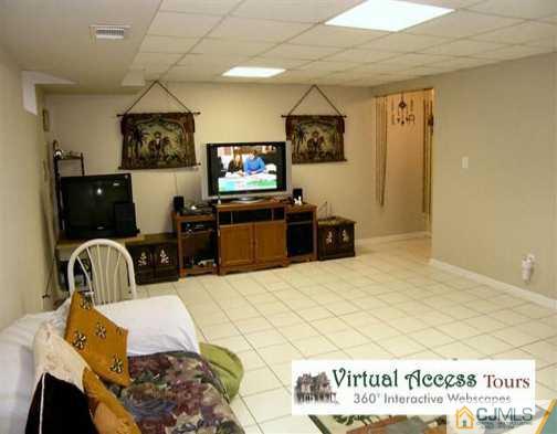 67 Springfield Road North Brunswick, NJ 08902 - Photo 6 of 8 a living room with furniture and a flat screen tv