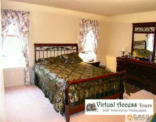 67 Springfield Road North Brunswick, NJ 08902 - Photo 7 of 8 a bedroom with a bed table and chair