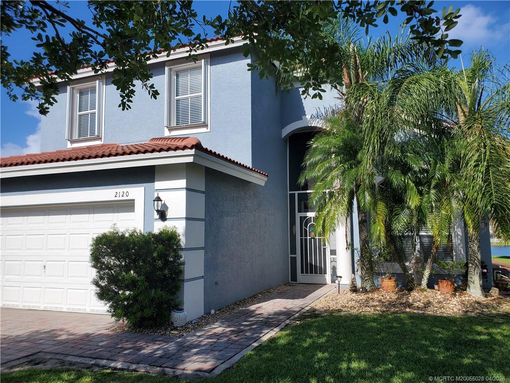 2120 Northwest Marsh Rabbit Lane Jensen Beach, FL 34957 - Photo 2 of 34 front view of a house with a yard