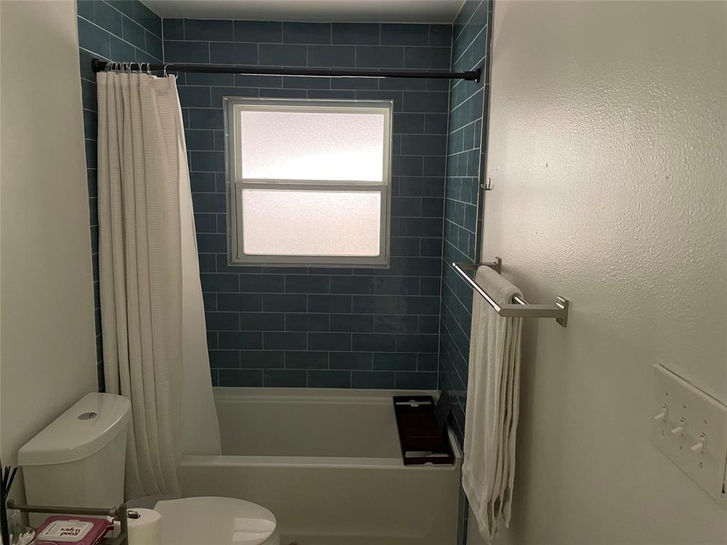 3208 Thompson Street Austin, TX 78702 - Photo 11 of 16 a bathroom with a shower and a toilet