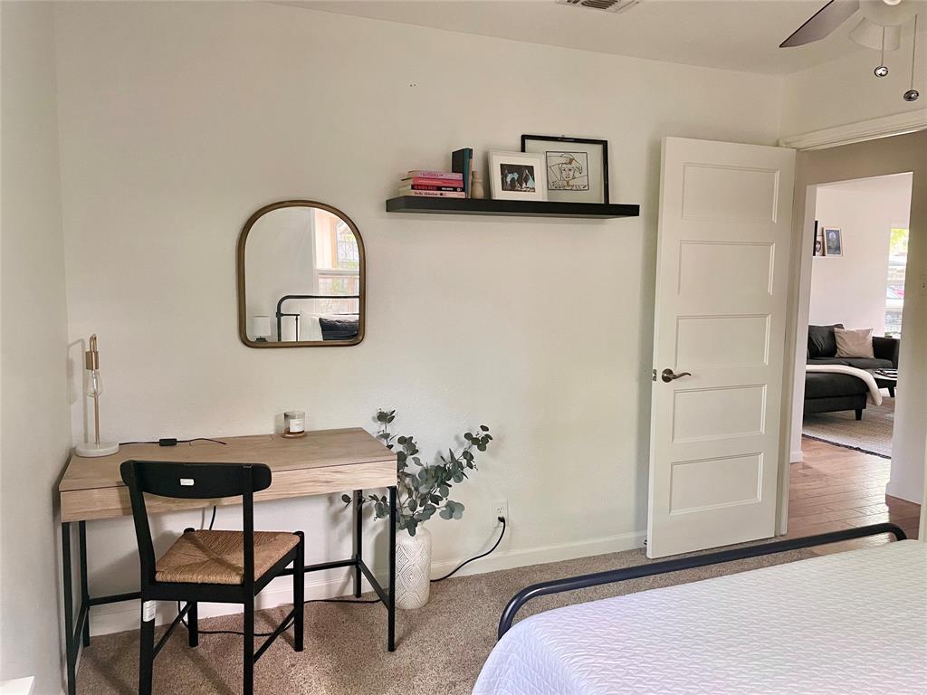 3208 Thompson Street Austin, TX 78702 - Photo 12 of 16 a bedroom with a bed and a table