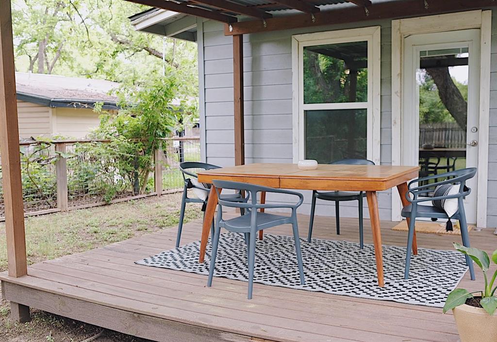 3208 Thompson Street Austin, TX 78702 - Photo 15 of 16 a view of a wooden deck with table and chairs