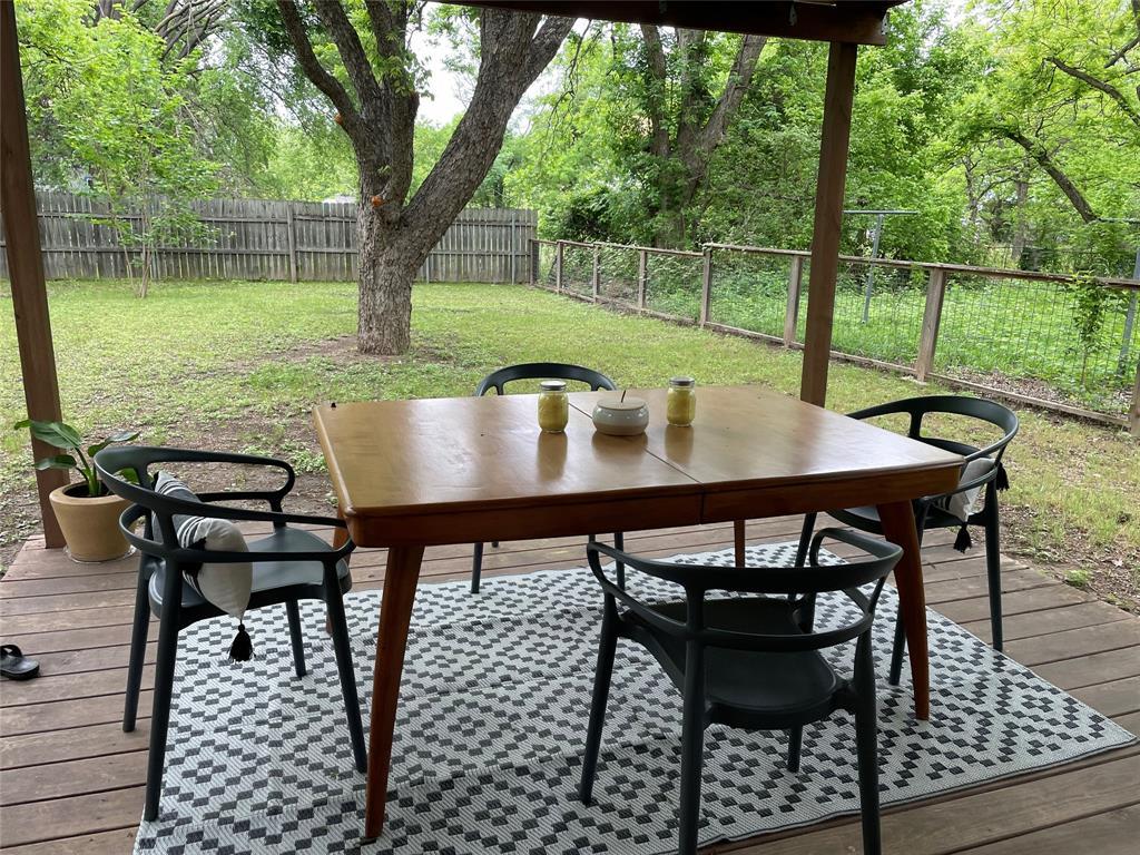 3208 Thompson Street Austin, TX 78702 - Photo 16 of 16 a view of a patio with table and chairs with wooden floor and fence