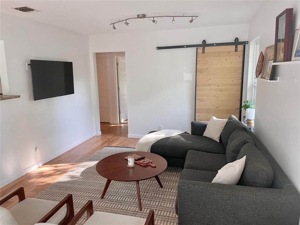 3208 Thompson Street Austin, TX 78702 - Photo 3 of 16 a living room with furniture and a flat screen tv