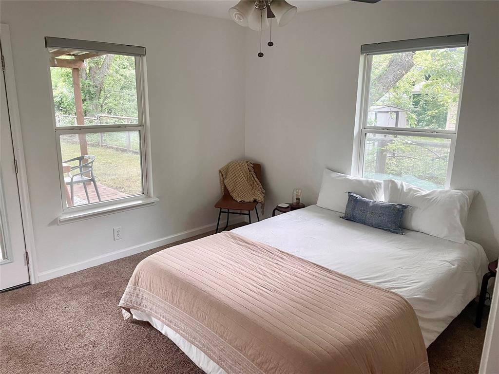 3208 Thompson Street Austin, TX 78702 - Photo 9 of 16 a bedroom with a bed and a window