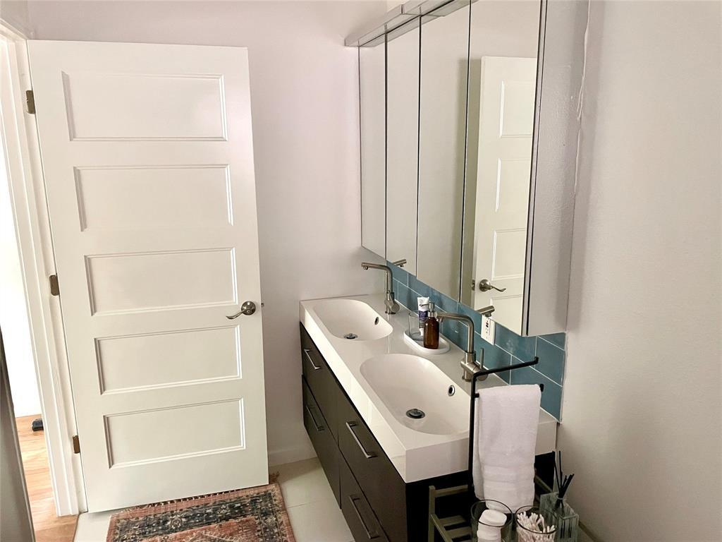 3208 Thompson Street Austin, TX 78702 - Photo 10 of 16 a bathroom with a sink and a mirror