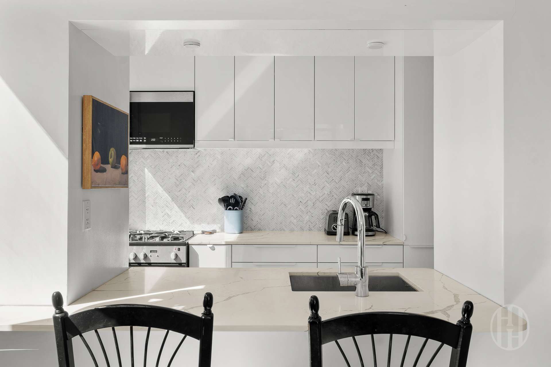2000 Broadway, Unit 7H Manhattan, NY 10023 - Photo 4 of 13 a kitchen with granite countertop a sink and white cabinets