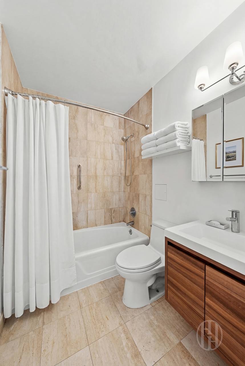 2000 Broadway, Unit 7H Manhattan, NY 10023 - Photo 9 of 13 a bathroom with a sink toilet and shower