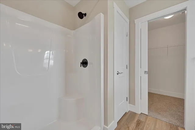 a view of a bathroom with a glass shower door